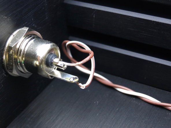 Photo 1 - Wires to middle of front panel power switch. Brown is barrel center, white/brn is tab (photo 3).