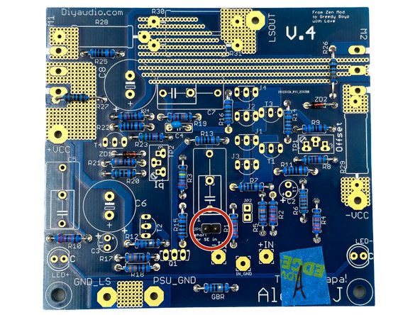 Photo 1 - A piece of tape is handy for holding the part in place while soldering.  Tack one lead in place and check that the part is seated firmly before soldering the second lead.