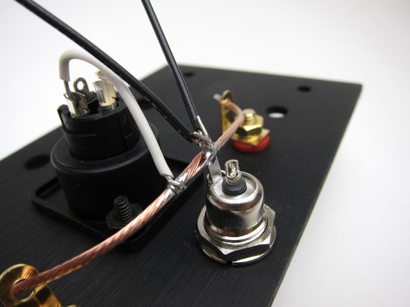 The tab of the barrel connector should be &quot;up&quot;. The wire may be soldered to the tab now, but don't solder it into the red (inboard) speaker jacks until you have the other speaker wires to the PCBs