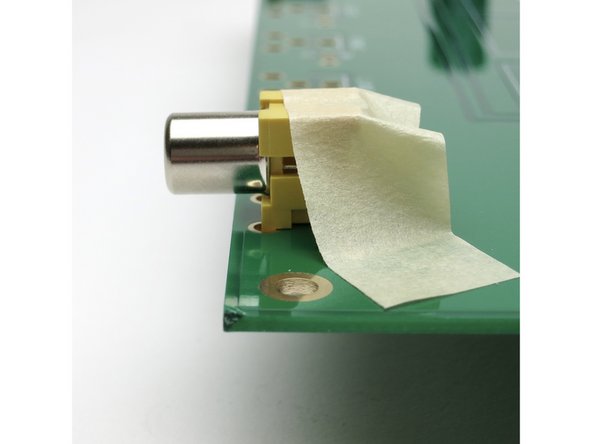 A bit of tape will hold the jack completely flat on the PCB for soldering.