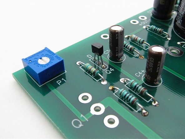 Align the flat of the small transistors with the silkscreen as shown.