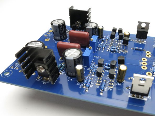 Photo 1 - Q1 and Q2 require small heatsinks.   The parts do not need to be electrically isolated from the heatsinks, but it cannot hurt to use a mica insulator and some thermal compound or a piece of Keratherm or similar.  The direction/orientation of the heatsinks is not critical.