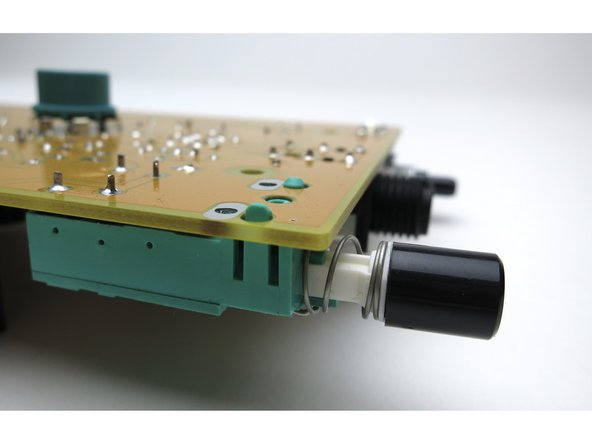 The switch has snap-in tabs as well as electrical connections. The black switch cap just pushes on.