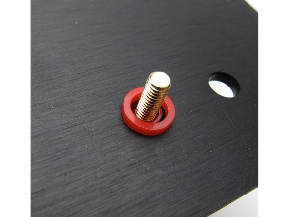 First image: The colored shoulder washer goes on the outside, through the hole. This is to align the post so that no metal touches the chassis. BUT, on some posts things sit more flush if the round washer is on the outside and the shoulder is on the inside - either way is fine, do what aligns better.