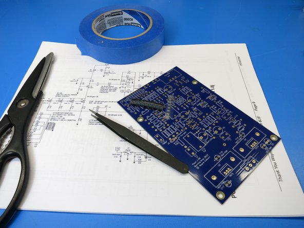 Solder the capacitors, the SMD JFETs (if using SMDs), op amps (if using SMD op amp fixed to PCB), and the optional balanced line driver chip.  See Photo 3 for an example of using tape to hold SMD device in place for soldering.