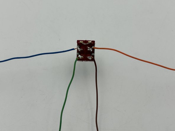 Separate the two other solid-colored strands from the CAT 5 twisted pairs.