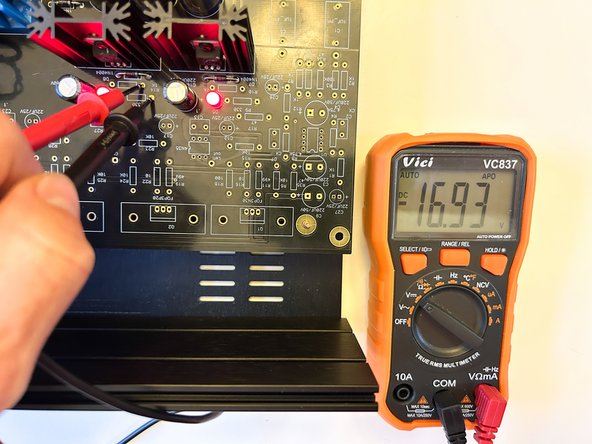With a DMM set for DCV, carefully place the black probe on the pad for R13 closest to C10.  Carefully place the red probe on the pad for R14 closest to C10.  It should read approximately -17VDC.  The polarity is important.
