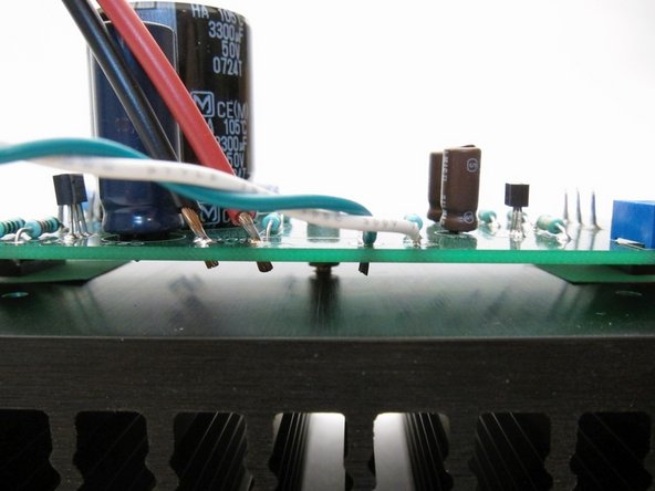 Since many wire connections need to be soldered from the top of the PCB, strip the insulation and trim so it sticks through only 1-2mm. Make sure it does not touch the heatsink!