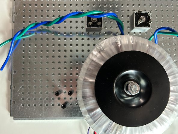 Make sure the Mains AC Hookup board is raised above the perforated base plate by at least a few millimeters.  Leads / traces / pads on the PCB MUST have appropriate clearance above the perforated base plate.