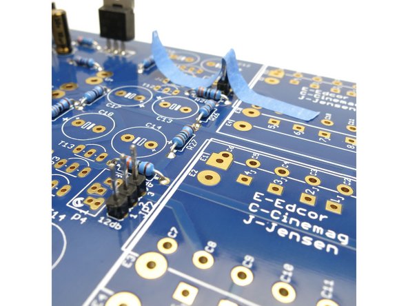Photo 1 -  It is extremely helpful to tape down the jumper headers before soldering. Make sure they are flat and touching the PCB.