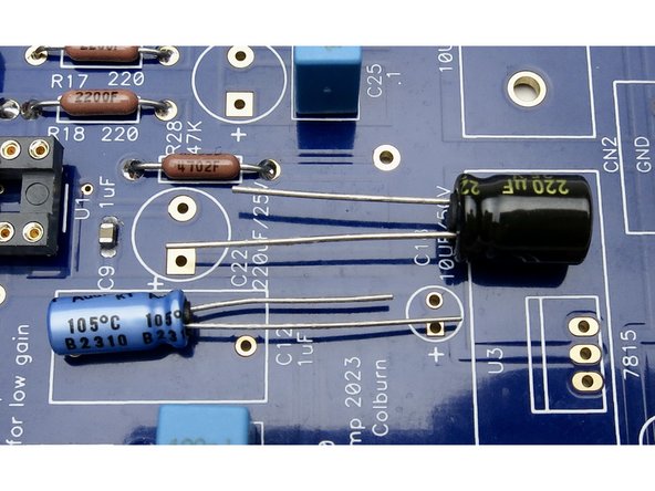 Electrolytic capacitor long leg (positive) to square hole.