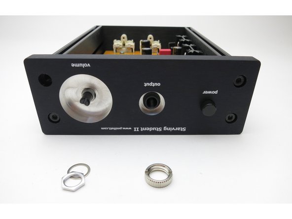 Slide the front panel into place. It might take a little jiggling to get everything to line up and fall into the holes. Fasten the panel to the extrusions using the black socket head screws supplied with the enclosure. Then, thread the nuts supplied with the kit onto the volume control shaft, and the headphone jack.