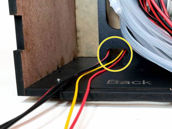 Insert the distance sensor wire and the LED wire through the small hole on the column.