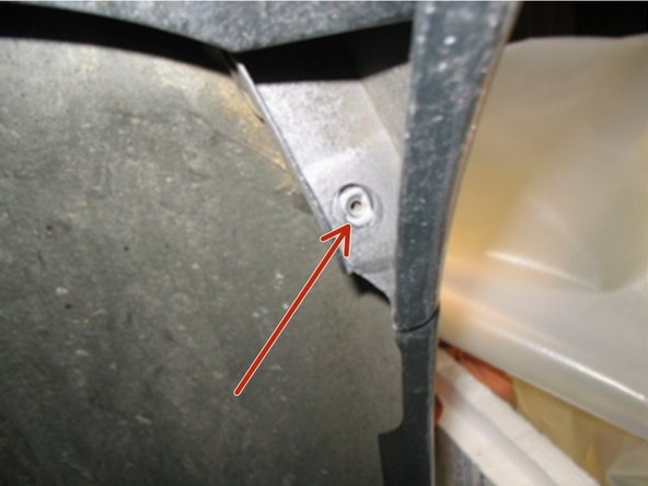 From underneath remove the screw that secures the tip of the bumper to the quarter panel.