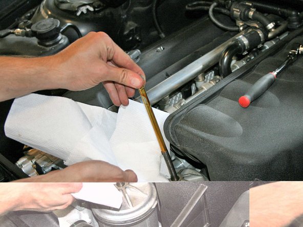Loosen the oil filter housing bolt with  a 13 mm socket. Take off the bolt and put it aside.  Have a towel or shop rag close by because some oil will drip.