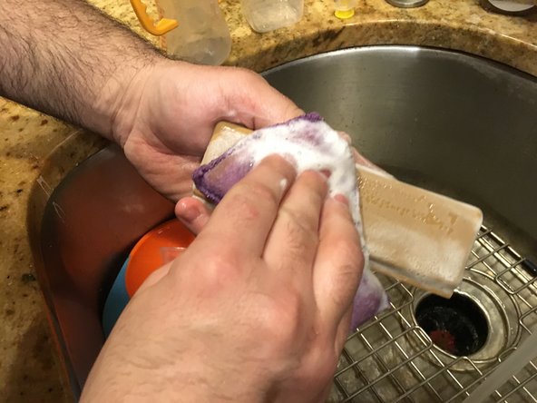 Wash the plastic piece with some dishwasher soap to remove any residue
