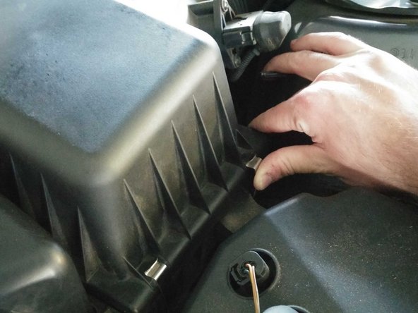 Reattach the metal clips on the right side of the air box.