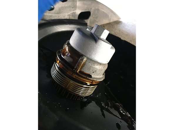 Using a Lexus/Toyota adapter , remove the oil filter housing cap