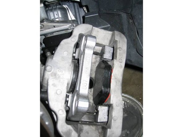 13. Now slip the caliper over the rotor and reinstall the bolts just to hold the caliper in place. This should easily fit over the caliper since you used the C clamp to make the space bigger. Do not tighten the bolts yet.