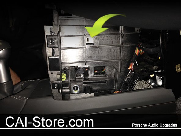 Remove the climate controls. To do this, simply locate the metal spring loaded tabs on either side of the climate control and press them in with your finger tips while pulling the climate control unit out towards yourself. Unplug and set aside. Tip: cover your center console and shifter with a towel to avoid scratches.