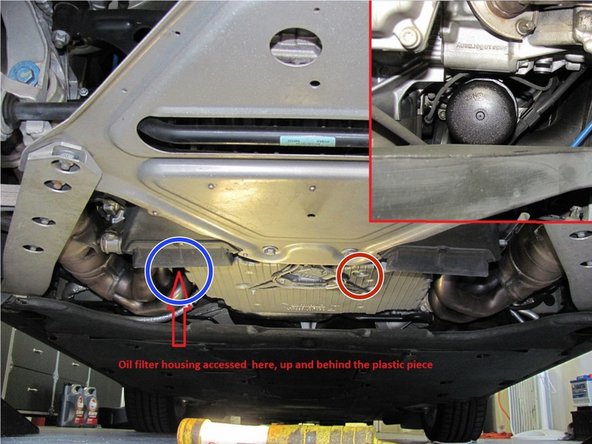 Here is a general concept of where the oil filter cover as well as the drain plug are located. This photo was taken from the back of the vehicle facing forwards. The picture shows the positioning of the drain plug.