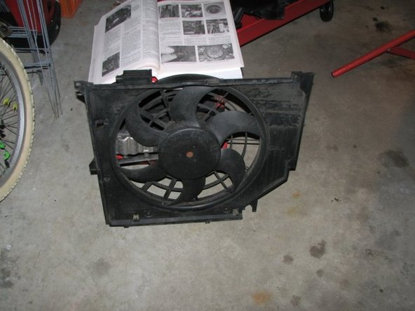 Once that is done you should be able to easily (and slowly) lift the fan/shroud combo out of the car, the right side may catch a bit so be careful. Here is the fan and shroud after it has been removed.