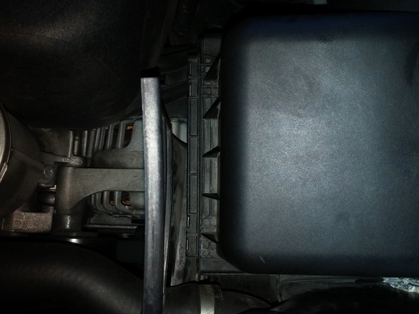 This might take some doing, as the new filter's gasket might be slightly larger than the old one, making it difficult to slip the lid back into place. You may need to use the flat head screwdriver to press the gasket under the lid. In the end, if the hooks are in place and the gasket isn't showing, the lid is in place.