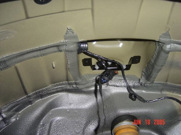 Remove the &quot;plug&quot; from the connector in the wheel well, and plug the connector into the siren. There is a plastic grommet that pushes into the bracket to support the weight of the siren when it is not mounted. Make sure you push this into the bracket before letting the siren &quot;hang&quot;.