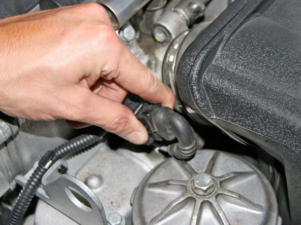 Disconnect the throttle position sensor (simply pinch the clip and pull).