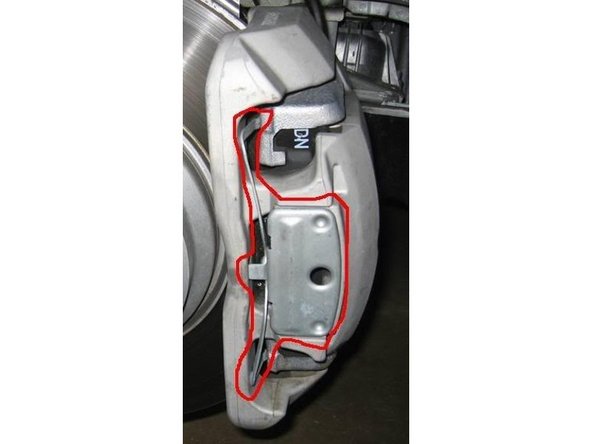 8. Once the C clamp won't tighten any more take out the old pads. There is a clip also that needs to come out to make the installation of the new pads easier. The clips is circled in the picture here.