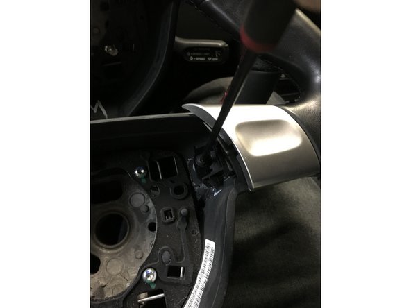 Using a delicate pry bar... remove the bottom trim piece. I had the best luck, working from the lowest point of the wheel.