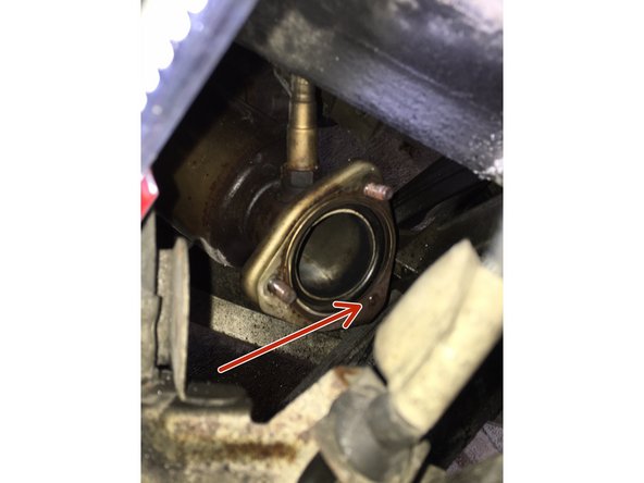 Ensure exhaust gasket is still attached to flange.