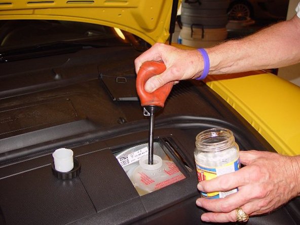 Remove as much fluid as possible without going below the minimum fill line on the side of the reservoir.