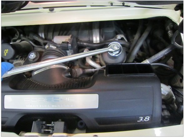 Using 36mm socket, carefully loosen oil filter housing cap.