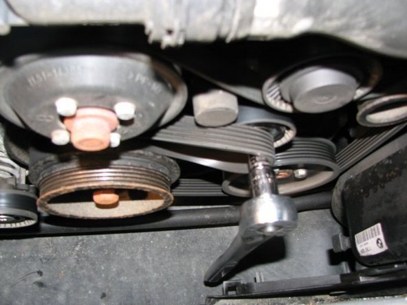 With the greater force needed this belt is a little trickier to get off but you can do it! Here it is almost off snagged on the bit. Just wiggle the bit out and the belt basically falls off. Once again my tensioner appeared to be in great shape so I didn't replace it.