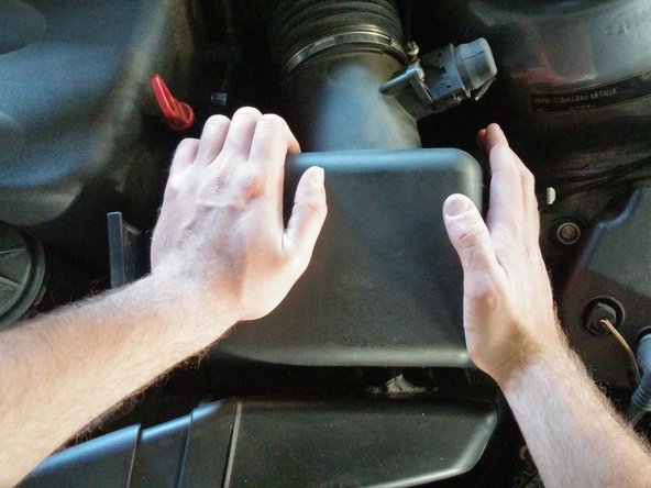 This might take some doing, as the new filter's gasket might be slightly larger than the old one, making it difficult to slip the lid back into place. You may need to use the flat head screwdriver to press the gasket under the lid. In the end, if the hooks are in place and the gasket isn't showing, the lid is in place.