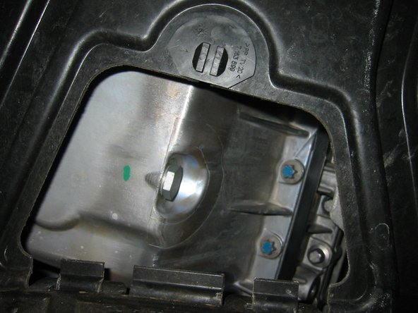 Loosen the bolt and drain the oil into a pan. About 7 quarts (6.5 L) will drain out.