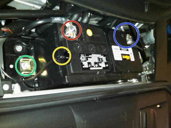 Install the battery clamp on the lower passenger side of the battery and tighten it to 17 ft.-lb.