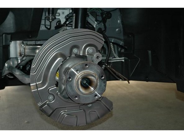 Trim the corners with the dremel so the bigger caliper can clear the heat sheild.