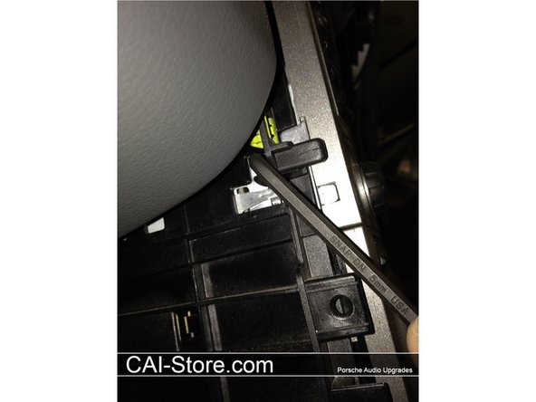 There are 2 retaining clips on each side of the radio chassis (4 total). These clips are locked or unlocked by rotating a plastic 5 mm Allen on each clip. Use an &quot;L&quot; shaped Allen wrench and turn 1/4 counter clockwise to release each retaining clip.