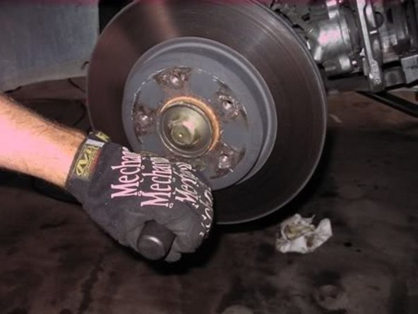 Grab hand impact driver with hex and remove brake disc retaining bolt.