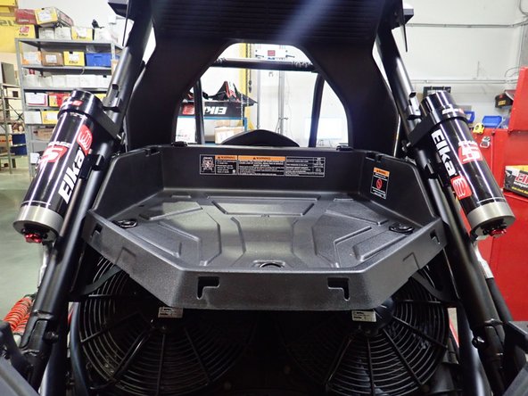 On Stage 2, Stage 4, and Stage 5 models the rebound adjuster located on lower eyelet of the shocks should be oriented towards the rear of the vehicle, as shown. (Right side shown ). If needed, you can turn the lower eyelet to orient properly.