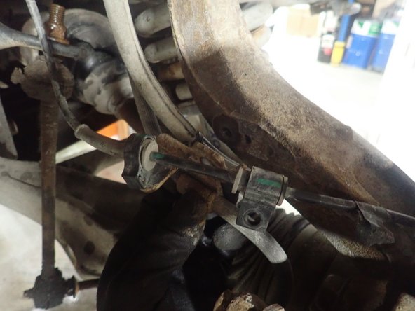 Lift the vehicle off the ground, then remove the front wheels.