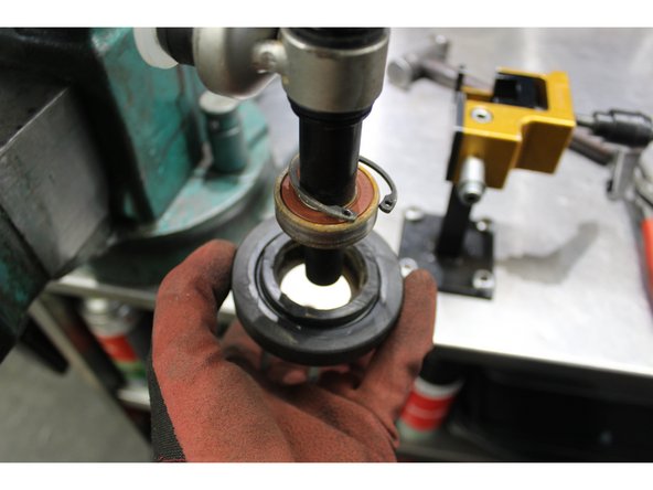 Installe the shaft gently in a vice, you can tap or press the bearing  off on one side.