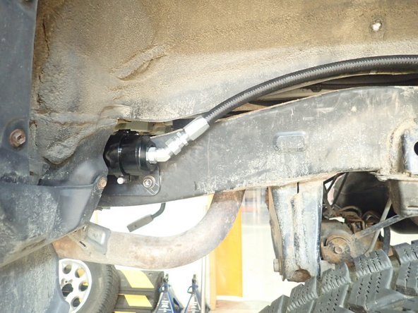 Slide reservoir into bracket clamps.