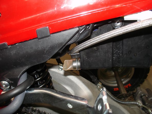 Pass the hose between the intake system and the air box.