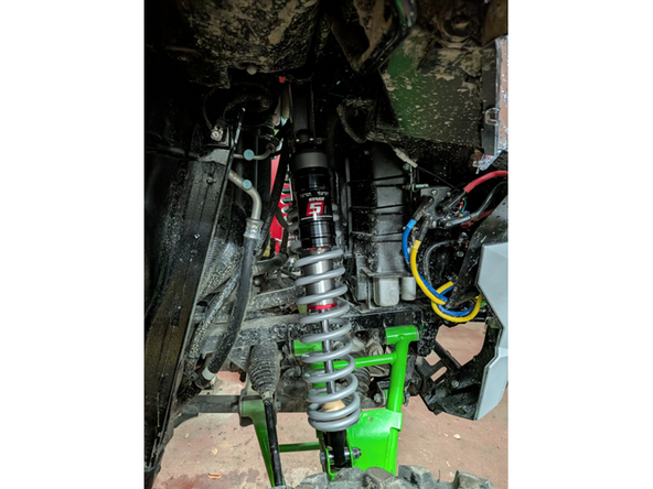 Install piggyback shock with the reservoir upward and facing outside the vehicle.
