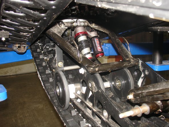 Install the Elka center shock with piggyback reservoir at the top and pointing towards the right side of the snowmobile as show on the photo.