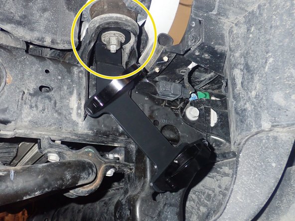 Remove nut that hold the front cab support, then install reservoir bracket as shown. ( Right side shown)