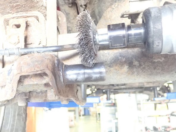 Remove OEM washers as shown by red circle. Clean carefully all the studs to remove rust, then apply grease on them.